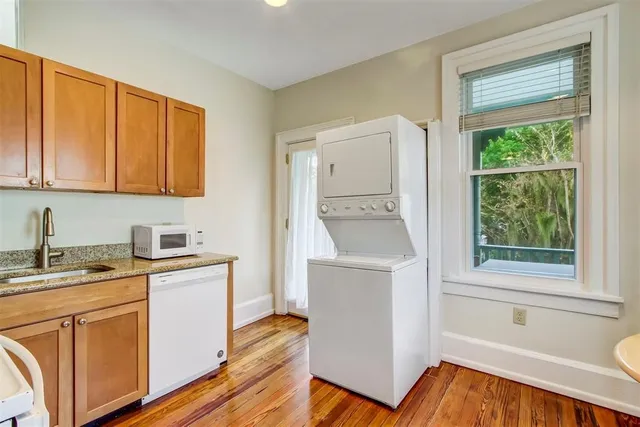 a view of cabinets with wooden floor and electronic appliances
