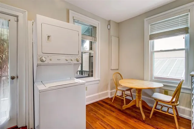 a view of a dining room with furniture and a window