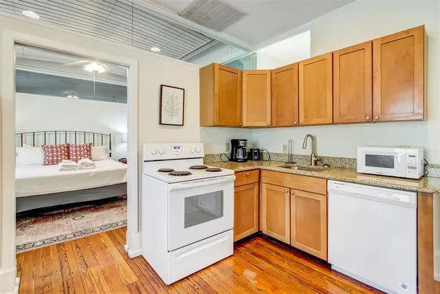 a kitchen with a stove a sink and a refrigerator