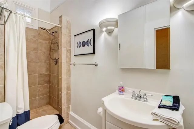 a bathroom with a sink toilet and shower