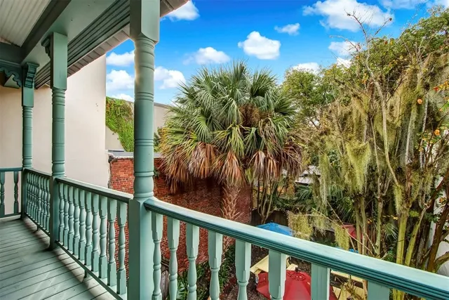 a view of a balcony with a tree