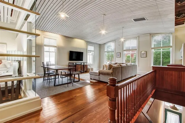 a view of a dining room with furniture window and wooden floor