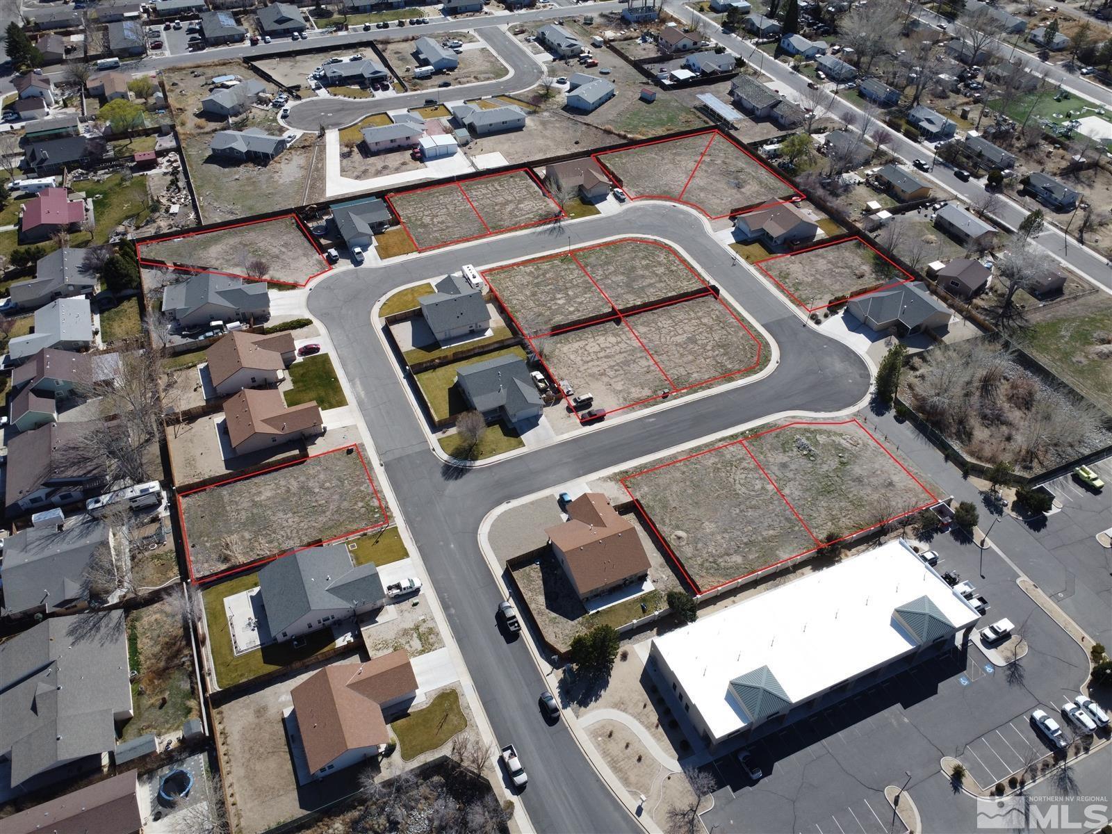 an aerial view of a multiple houses with a yard