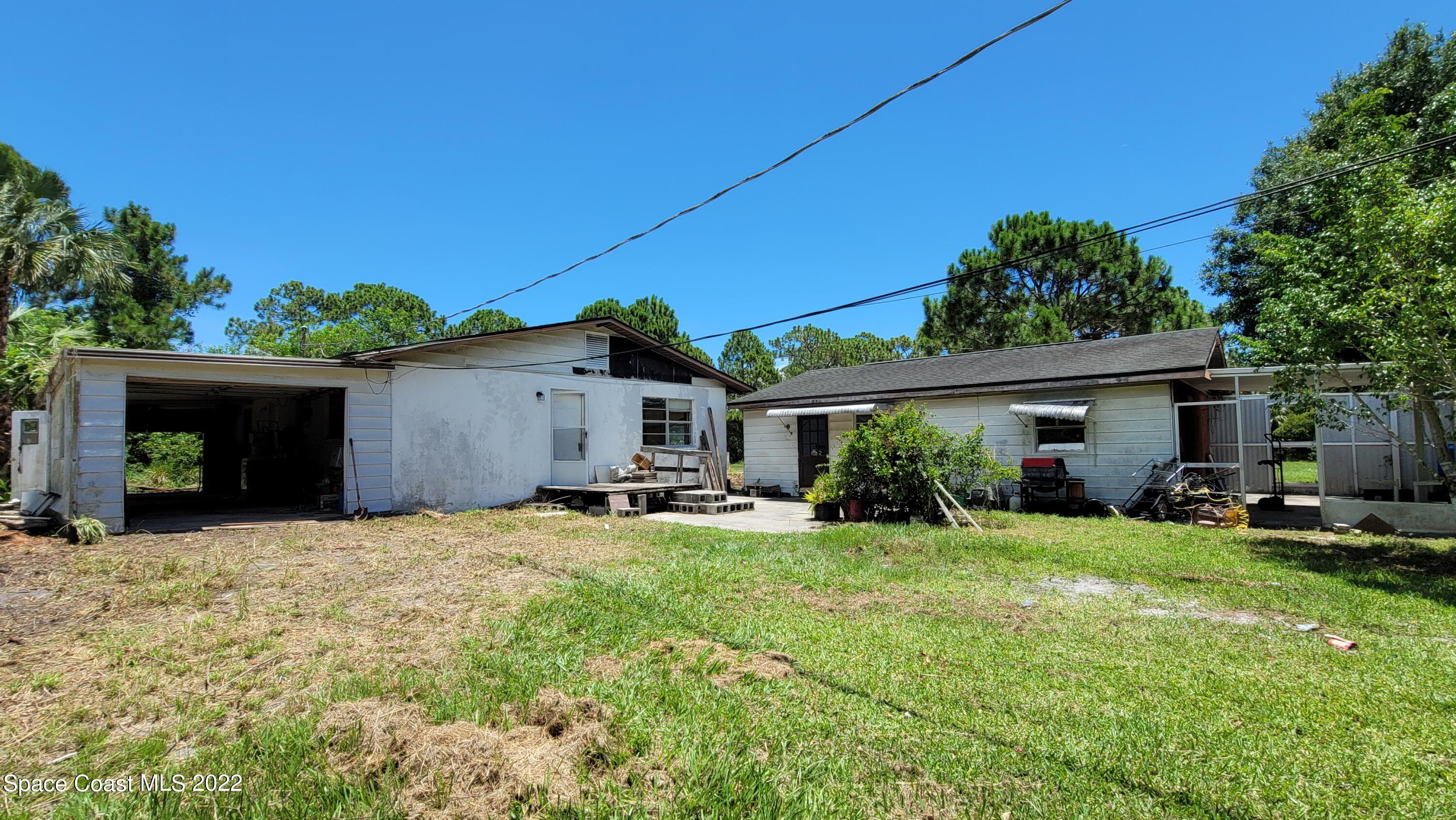 1910 Atz Road Malabar, FL 32950 - Photo 1 of 58 a view of a house with a patio and a yard