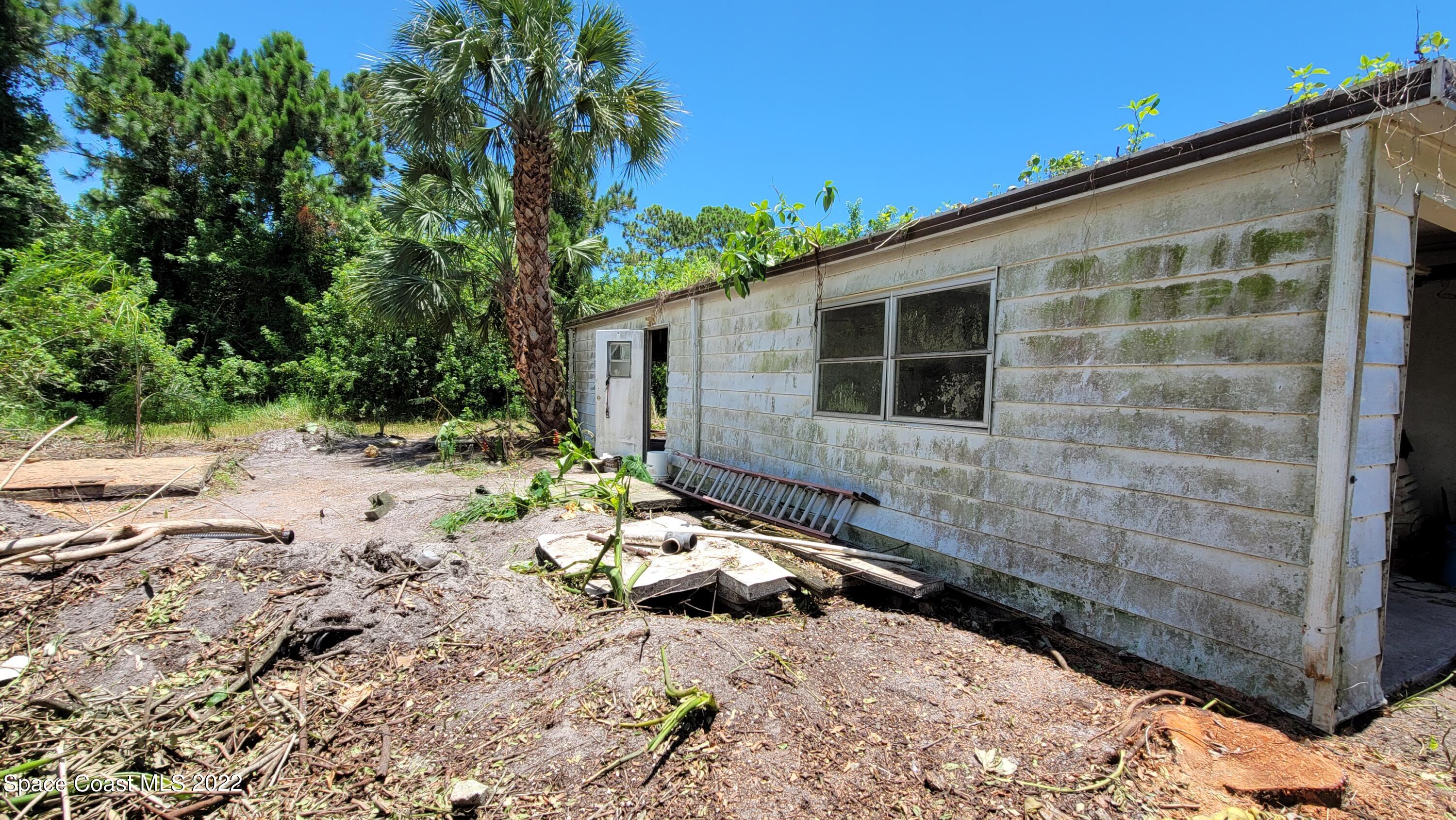 1910 Atz Road Malabar, FL 32950 - Photo 14 of 58 a backyard of a house with lots of green space