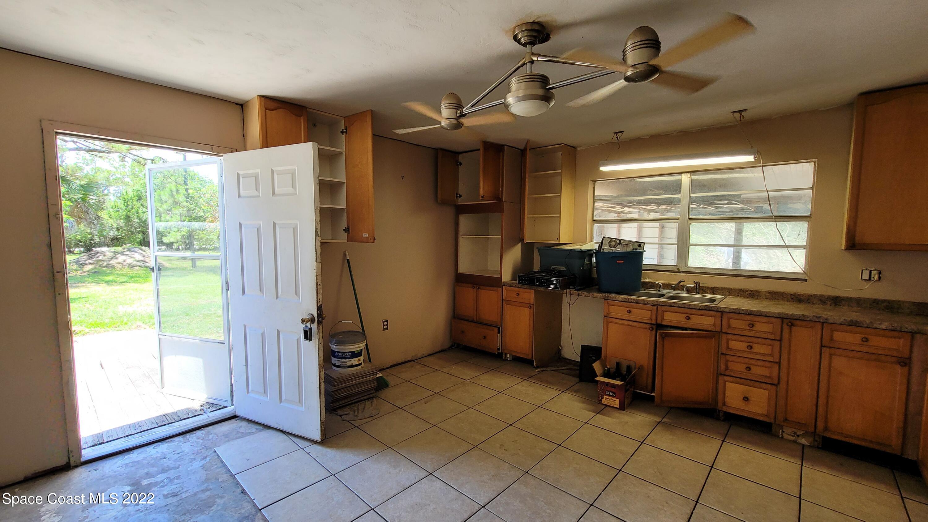 1910 Atz Road Malabar, FL 32950 - Photo 20 of 58 a kitchen with stainless steel appliances granite countertop a refrigerator and a sink