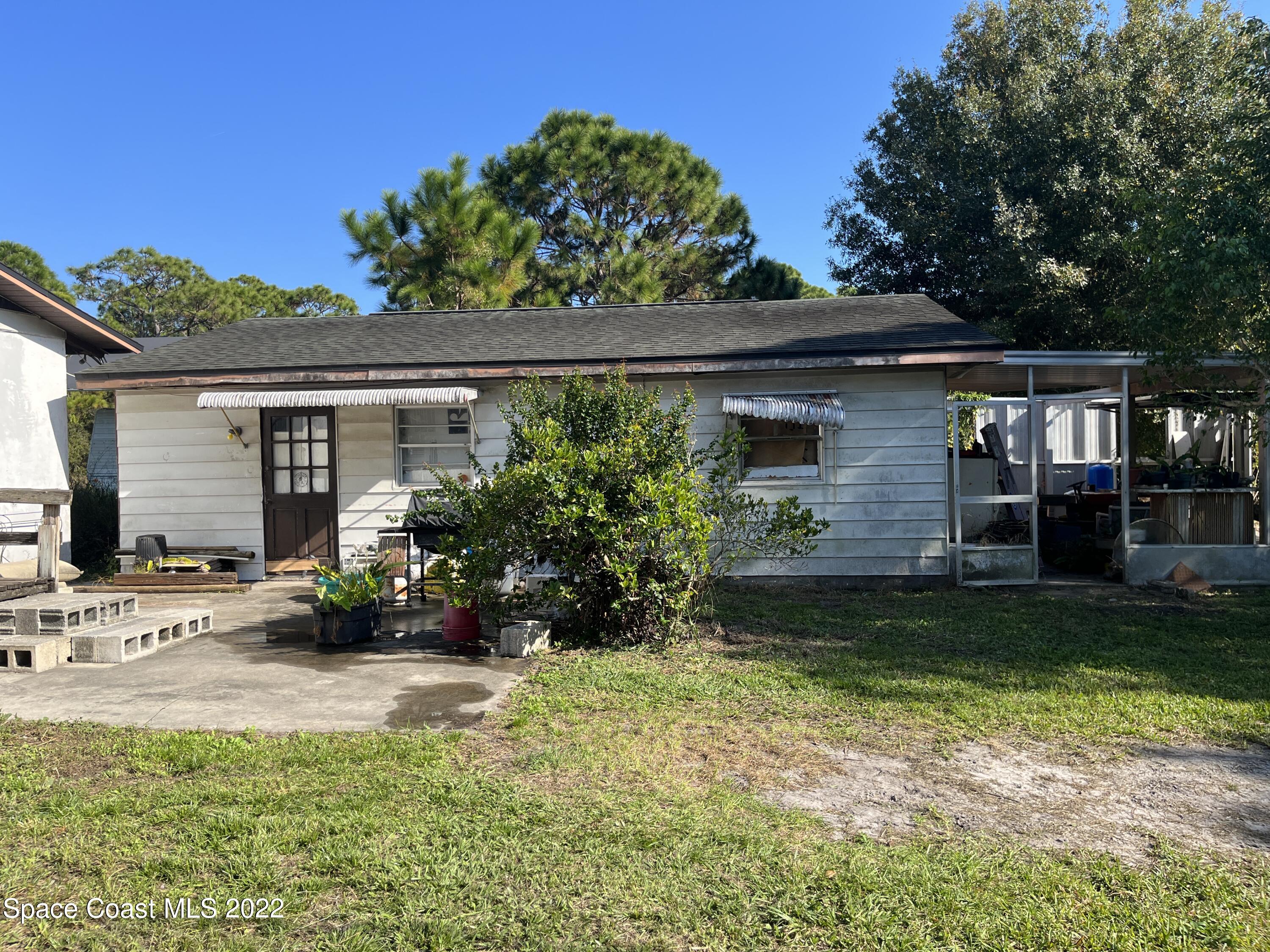 1910 Atz Road Malabar, FL 32950 - Photo 2 of 58 front view of a house with a yard