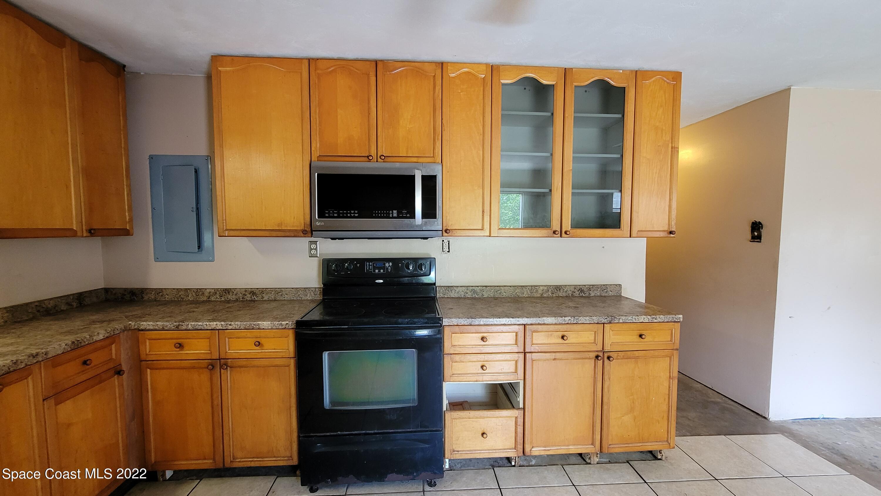 1910 Atz Road Malabar, FL 32950 - Photo 22 of 58 a kitchen with granite countertop cabinets stainless steel appliances and a counter space