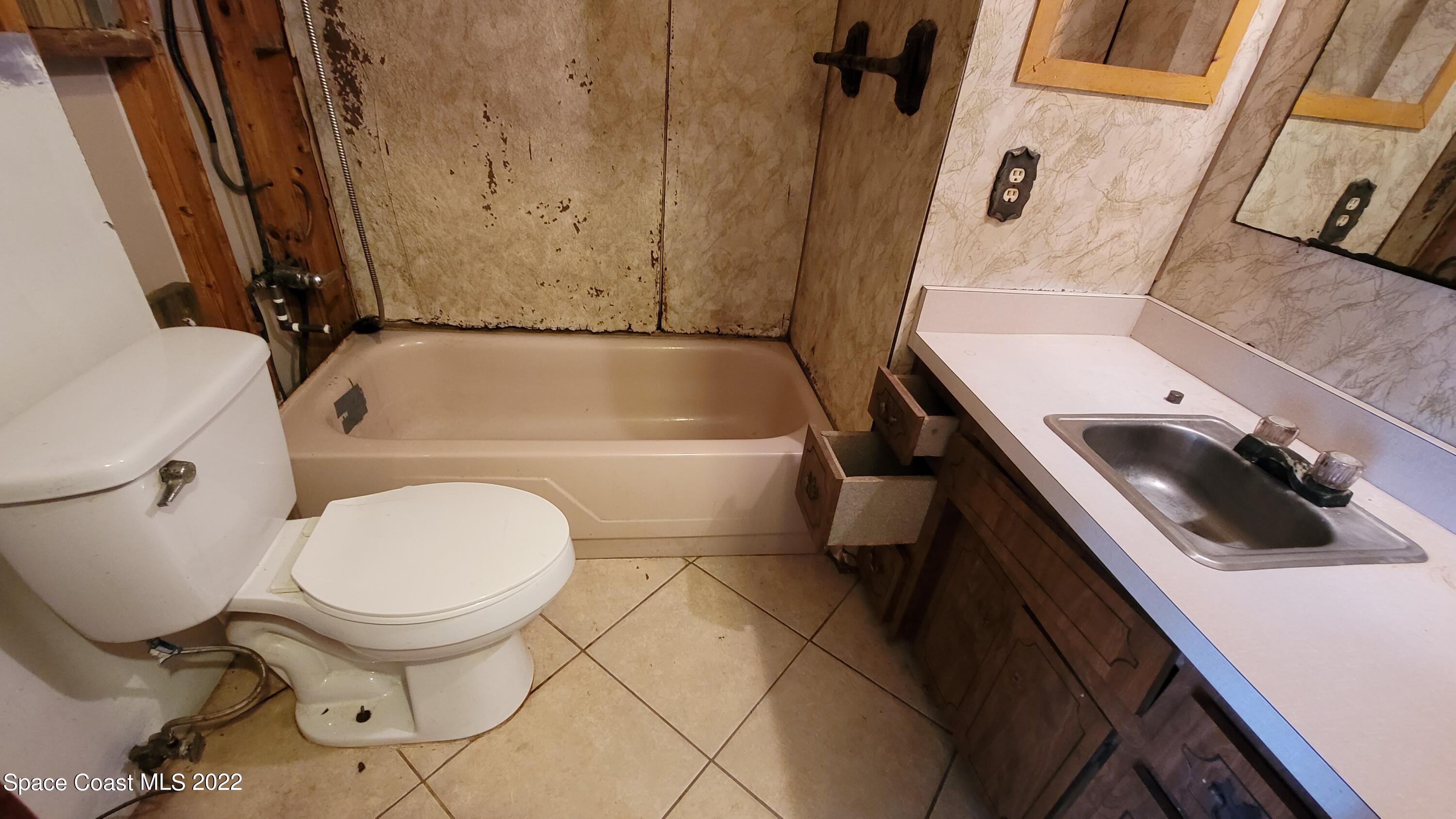 1910 Atz Road Malabar, FL 32950 - Photo 24 of 58 a bathroom with a tub toilet and a sink