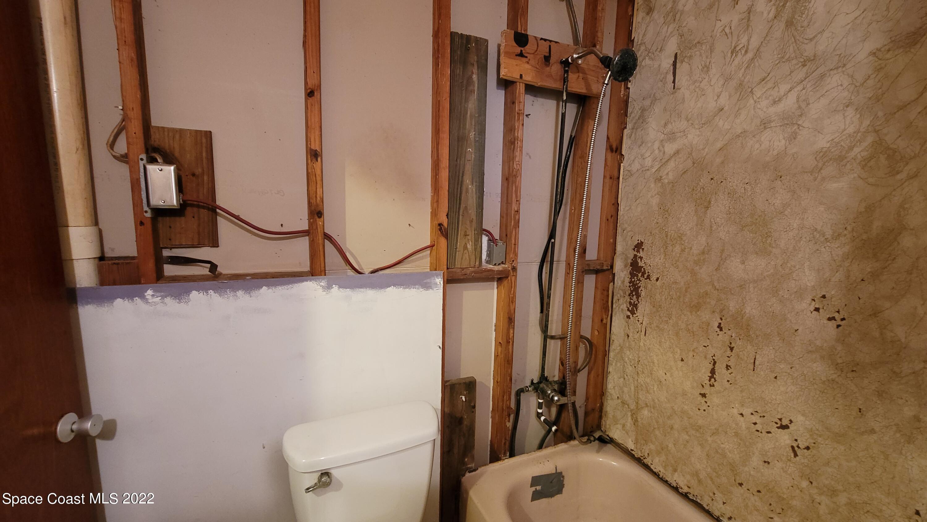 1910 Atz Road Malabar, FL 32950 - Photo 25 of 58 a bathroom with a granite countertop sink toilet and shower