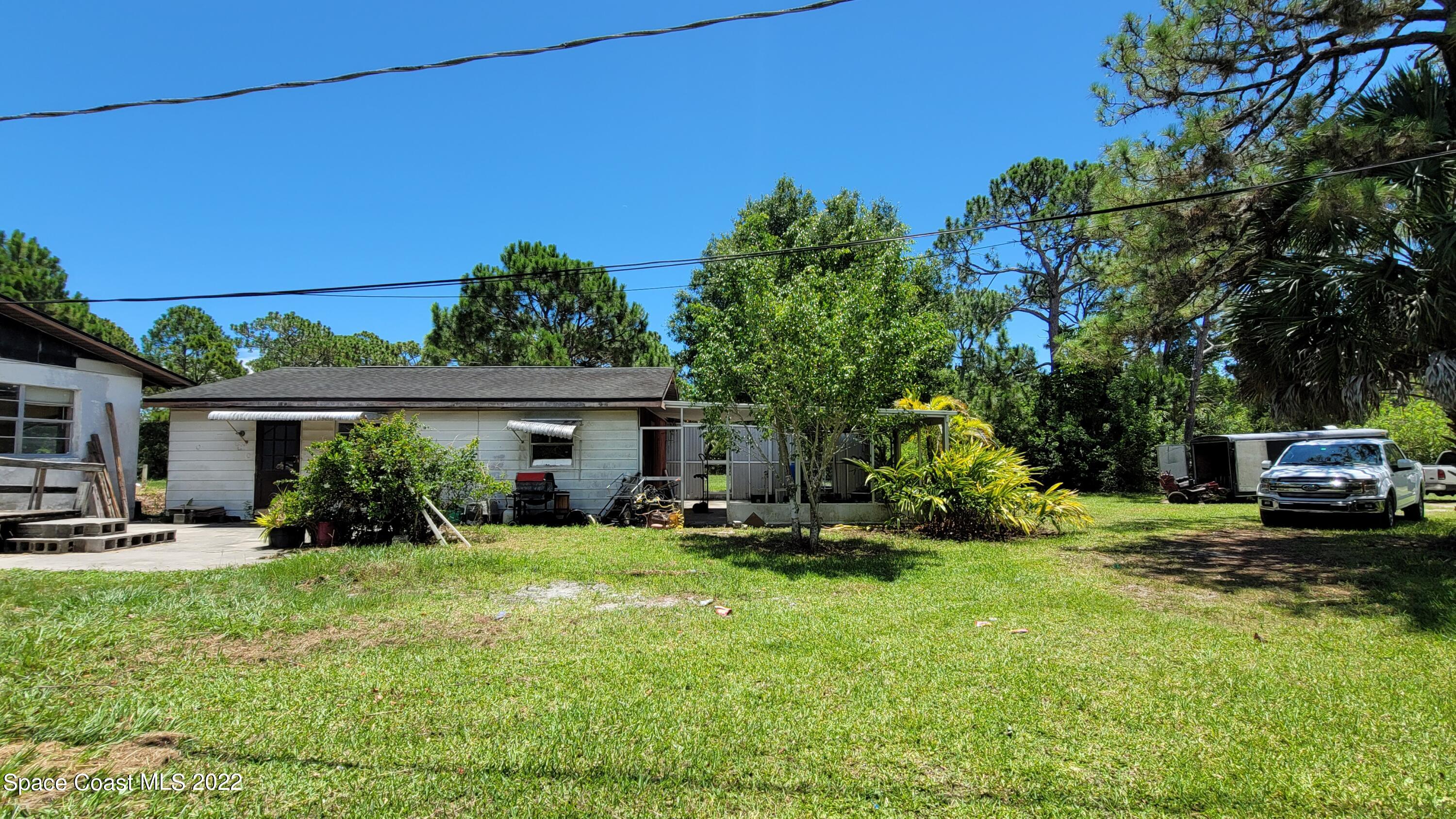 1910 Atz Road Malabar, FL 32950 - Photo 3 of 58 a view of a house with backyard sitting area and garden