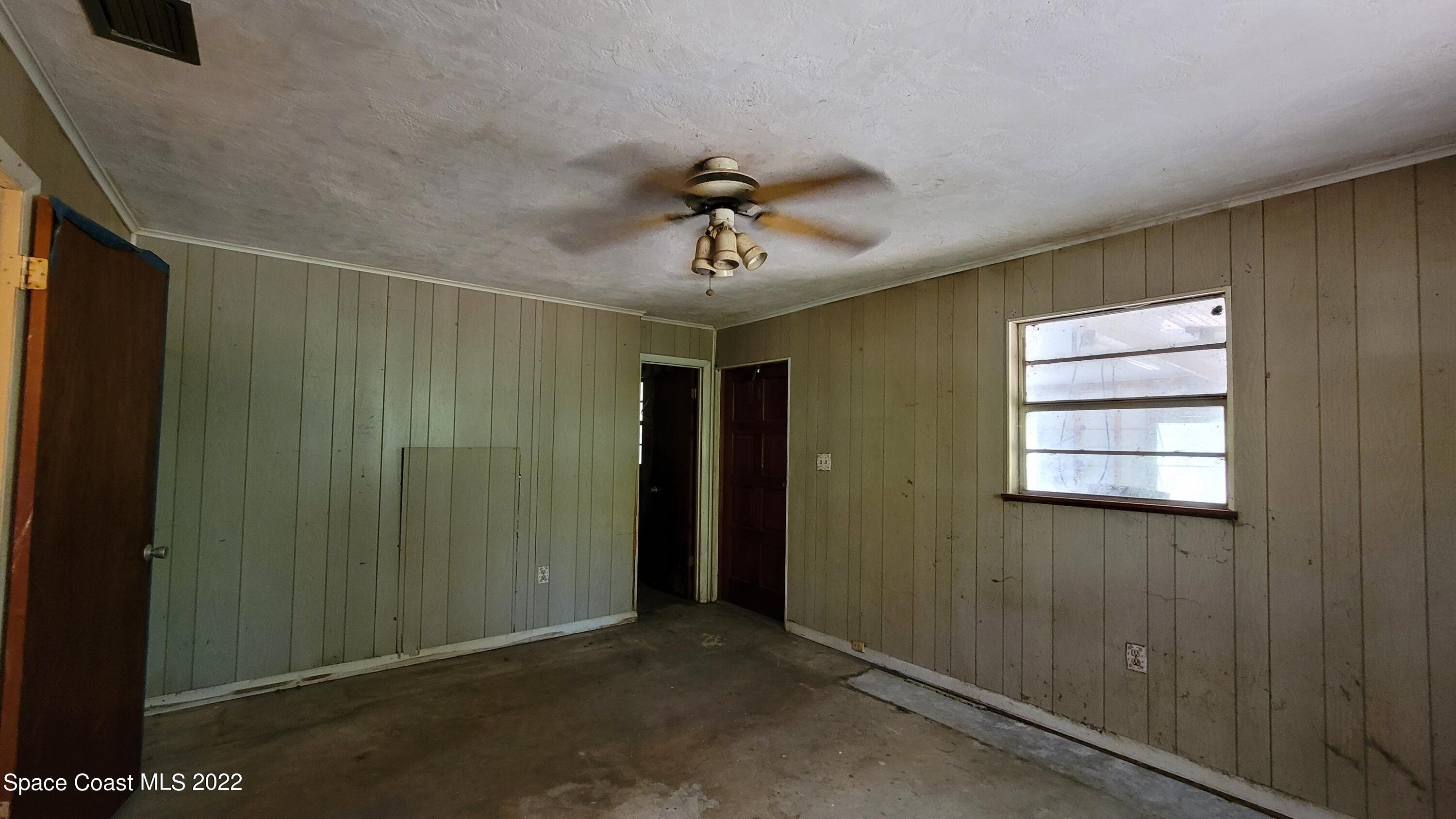 1910 Atz Road Malabar, FL 32950 - Photo 32 of 58 a view of a room with a ceiling fan and a window