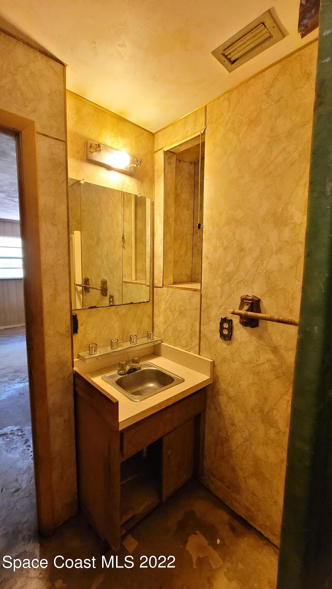 1910 Atz Road Malabar, FL 32950 - Photo 34 of 58 a bathroom with a sink and a shower