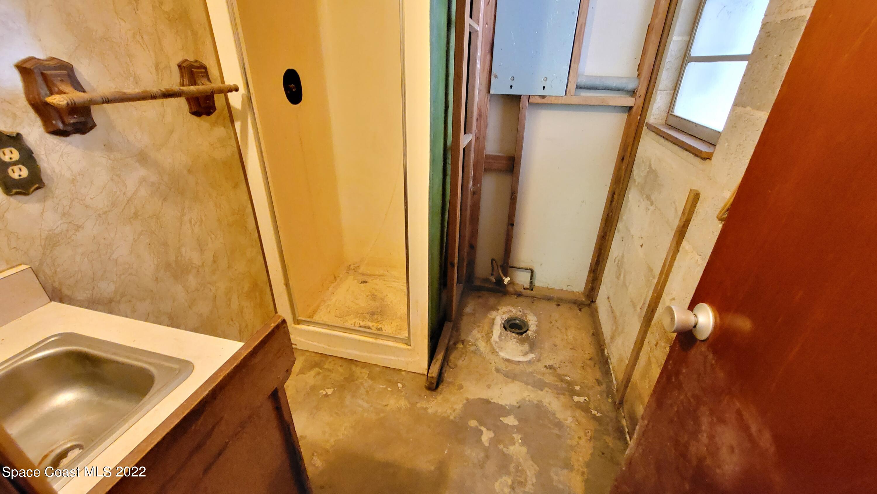 1910 Atz Road Malabar, FL 32950 - Photo 36 of 58 a bathroom with a tub sink and a mirror