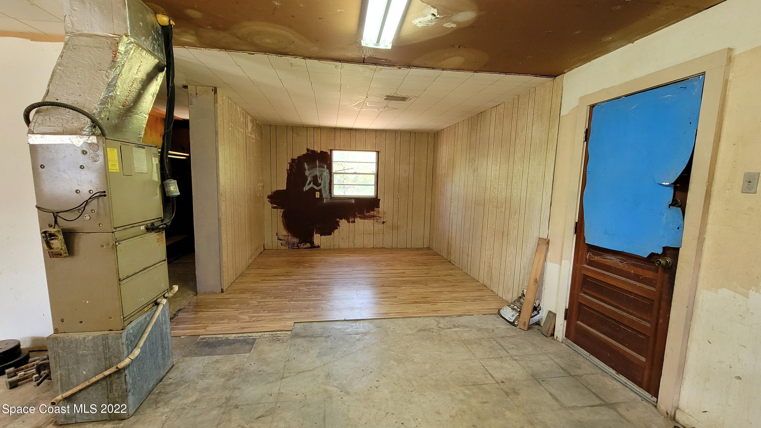 1910 Atz Road Malabar, FL 32950 - Photo 43 of 58 a view of a hallway with wooden walls and entryway