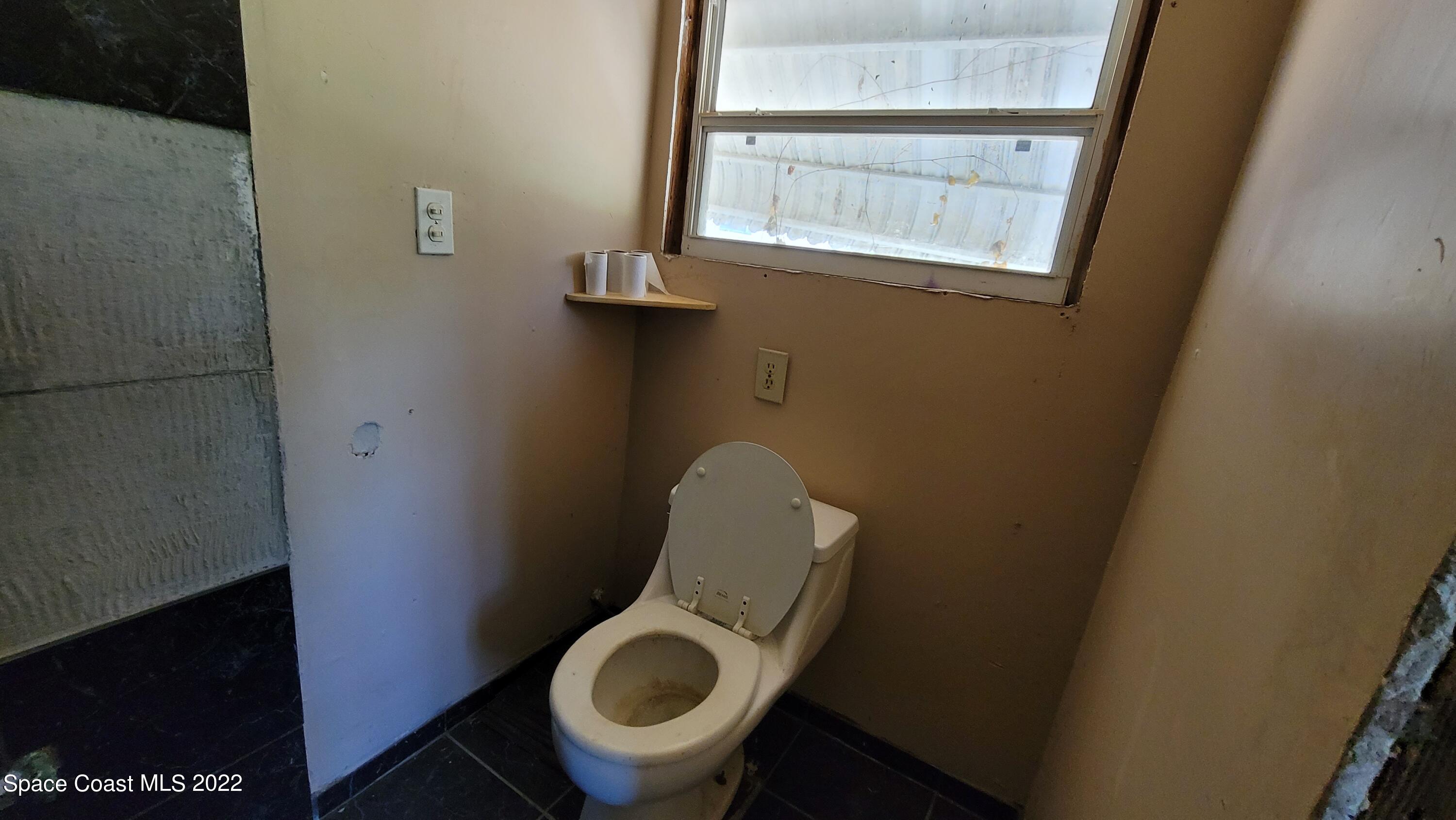 1910 Atz Road Malabar, FL 32950 - Photo 52 of 58 a bathroom with a toilet and a window