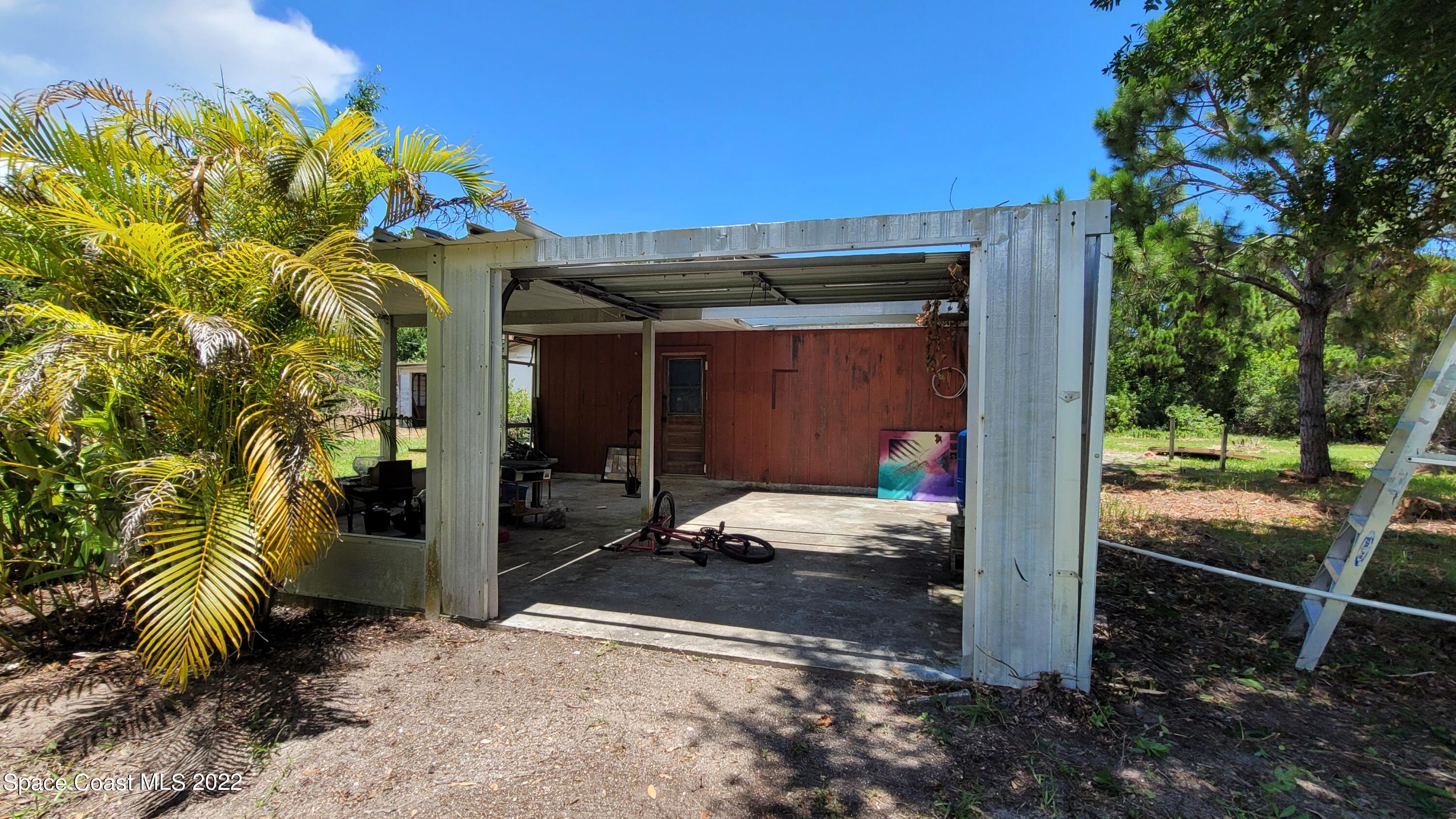 1910 Atz Road Malabar, FL 32950 - Photo 6 of 58 a view of a porch with furniture and floor to ceiling window