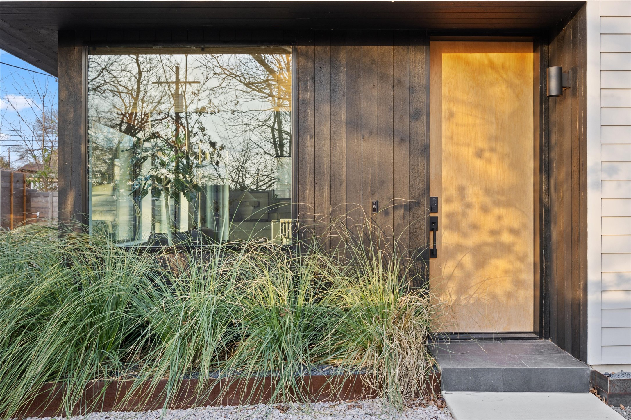 4604 South 2nd Street, Unit 2 Austin, TX 78745 - Photo 2 of 35 The front entry features Shou Sugi Ban exterior wood siding, for a Japanese flair. Low maintenance perennial grasses complement the vibe.