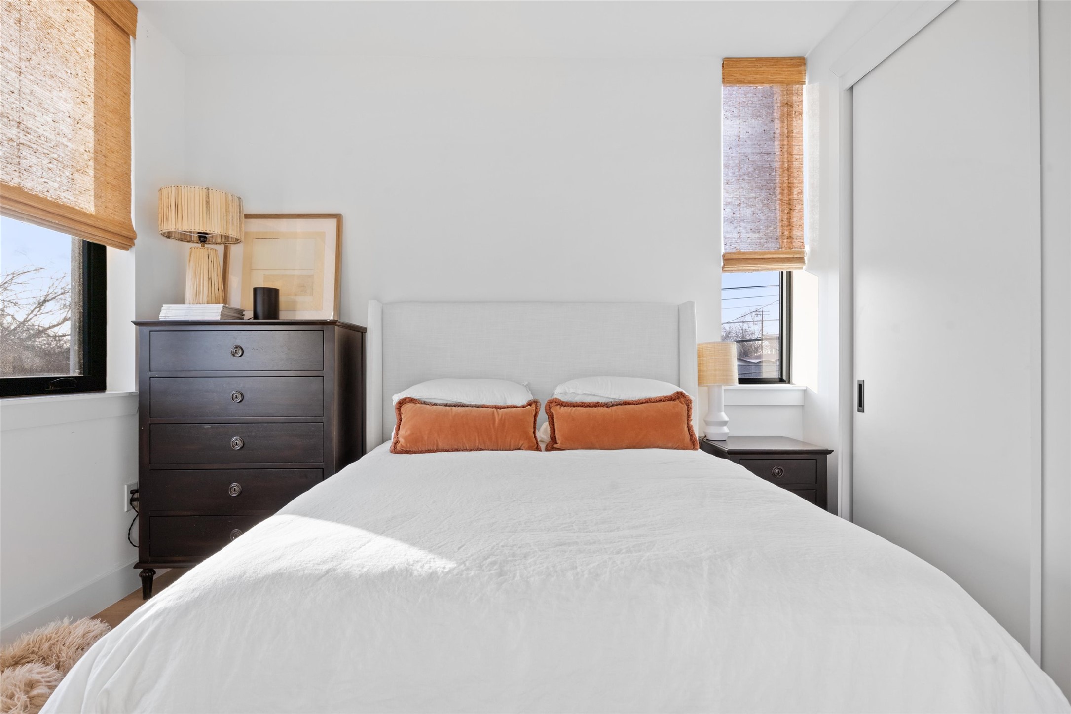 4604 South 2nd Street, Unit 2 Austin, TX 78745 - Photo 20 of 35 Front upstairs bedroom accommodates a queen bed. Blinds provide a warm organic touch against the white walls.