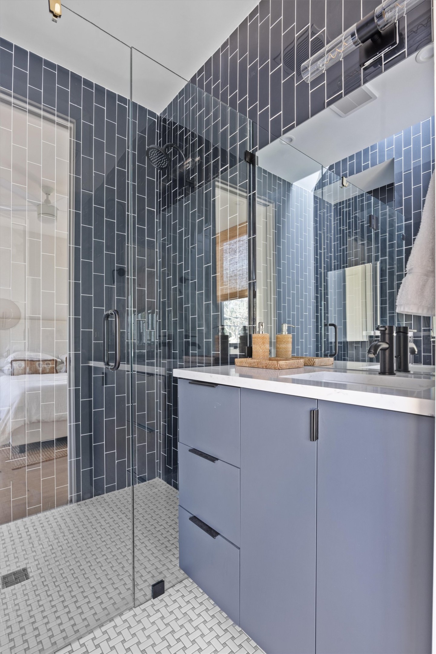 4604 South 2nd Street, Unit 2 Austin, TX 78745 - Photo 26 of 35 Back bedroom also has an ensuite bath with skylight; Floor-to-ceiling vertical tile in walk-in shower with seamless glass enclosure, quartz countertops.