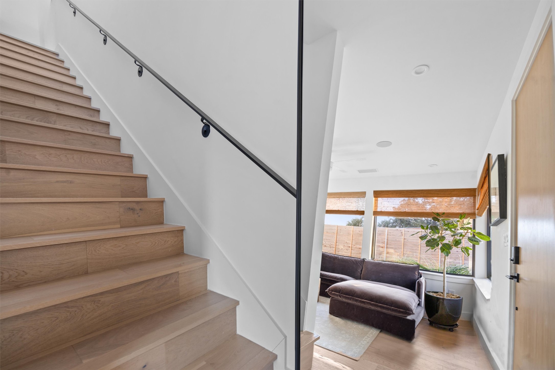 4604 South 2nd Street, Unit 2 Austin, TX 78745 - Photo 30 of 35 Wooden stairwell with modern steel handrail (note: wall mirror at bottom of stairs is reflecting the living room and front door).