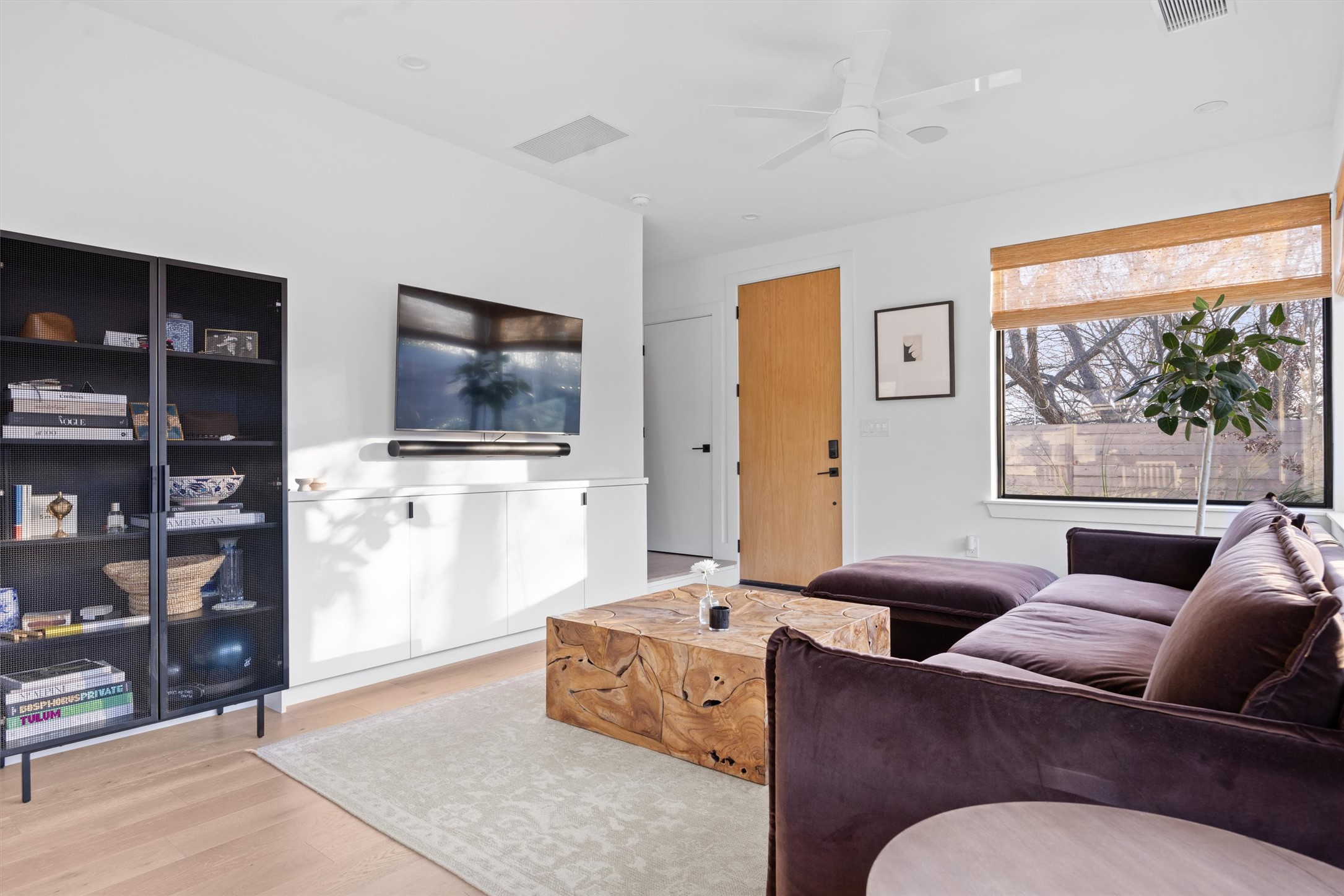 4604 South 2nd Street, Unit 2 Austin, TX 78745 - Photo 5 of 35 Coat closet and stairs to the left of front door. Built-in media cabinet and storage below TV.
