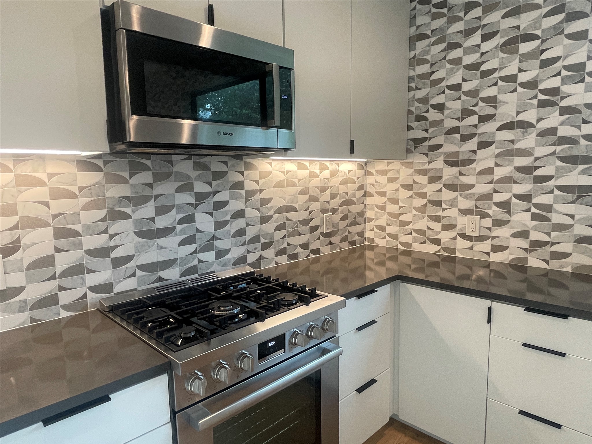 4604 South 2nd Street, Unit 2 Austin, TX 78745 - Photo 8 of 35 Bosch 36-inch industrial-style gas range and convection microwave; stunning Mila Thassos Carrara Marble Mosaic tile.