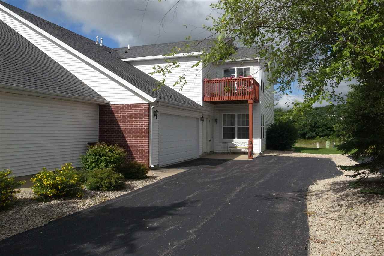 10192 Metalmark Lane, Unit 4 Roscoe, IL 61073 - Photo 1 of 16 a front view of a house with a garden