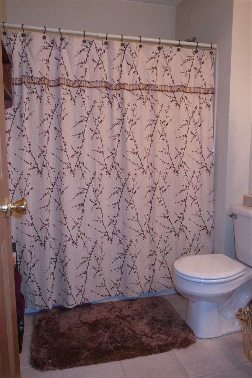 10192 Metalmark Lane, Unit 4 Roscoe, IL 61073 - Photo 11 of 16 a bathroom with a toilet and a shower curtain
