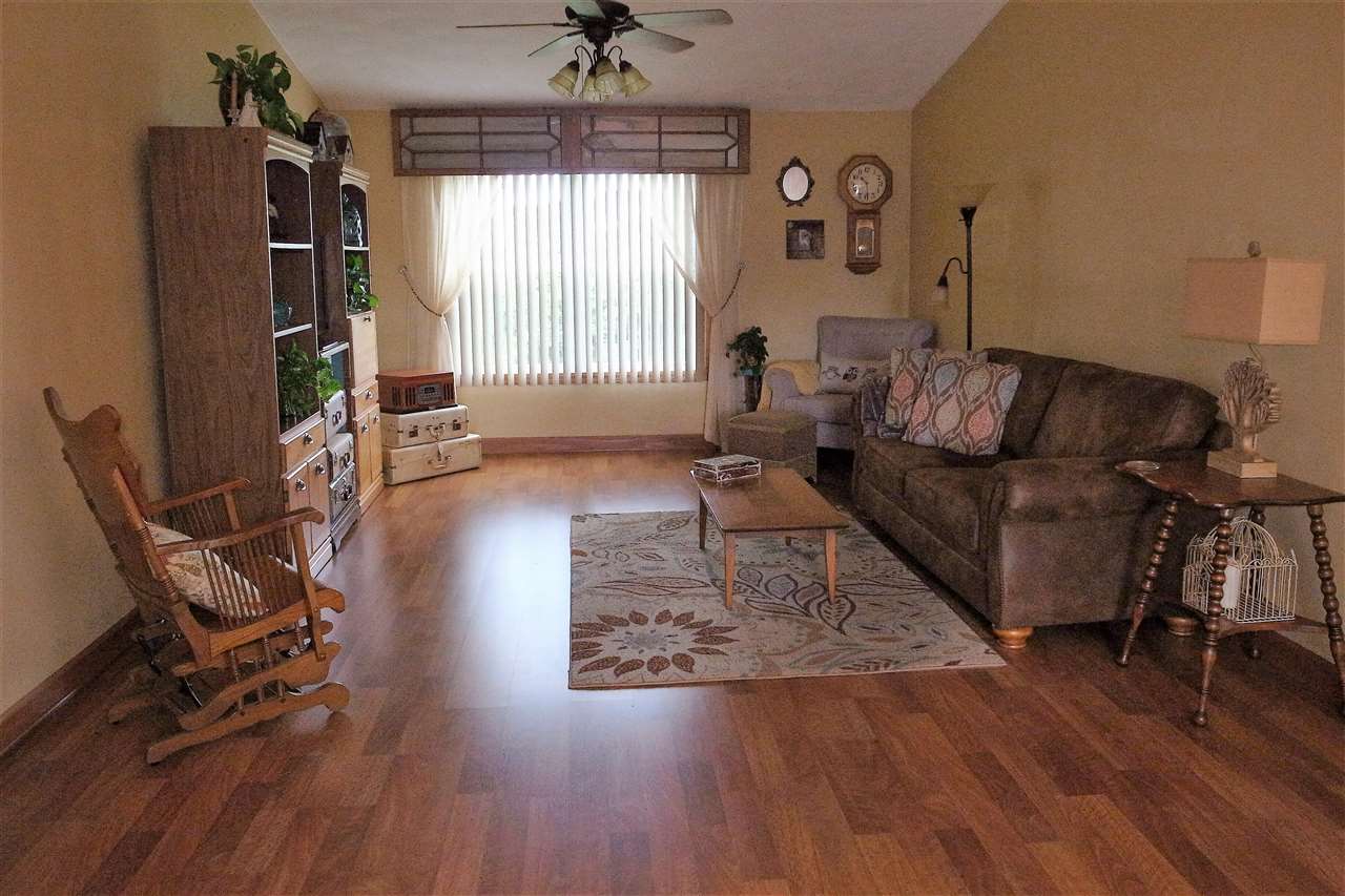 10192 Metalmark Lane, Unit 4 Roscoe, IL 61073 - Photo 2 of 16 a living room with furniture window and wooden floor