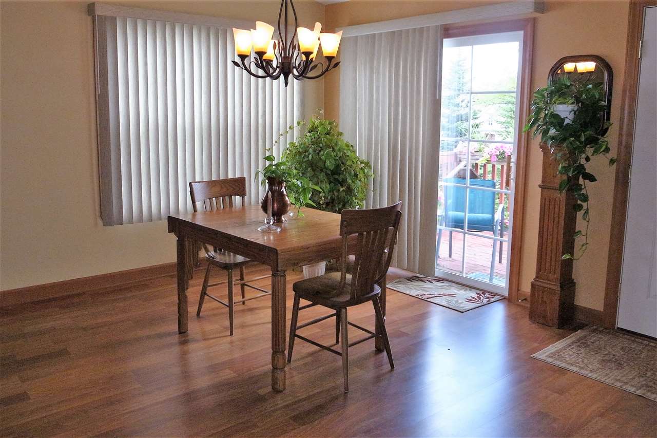 10192 Metalmark Lane, Unit 4 Roscoe, IL 61073 - Photo 3 of 16 a view of a dining room with furniture window and wooden floor