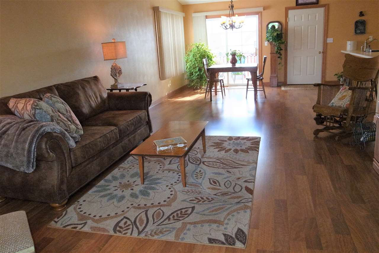 10192 Metalmark Lane, Unit 4 Roscoe, IL 61073 - Photo 4 of 16 a living room with furniture and wooden floor