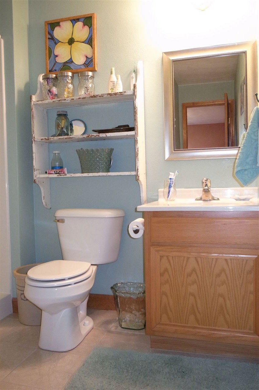 10192 Metalmark Lane, Unit 4 Roscoe, IL 61073 - Photo 9 of 16 a bathroom with a toilet sink and mirror