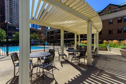 a view of a patio with table and chairs and potted plants