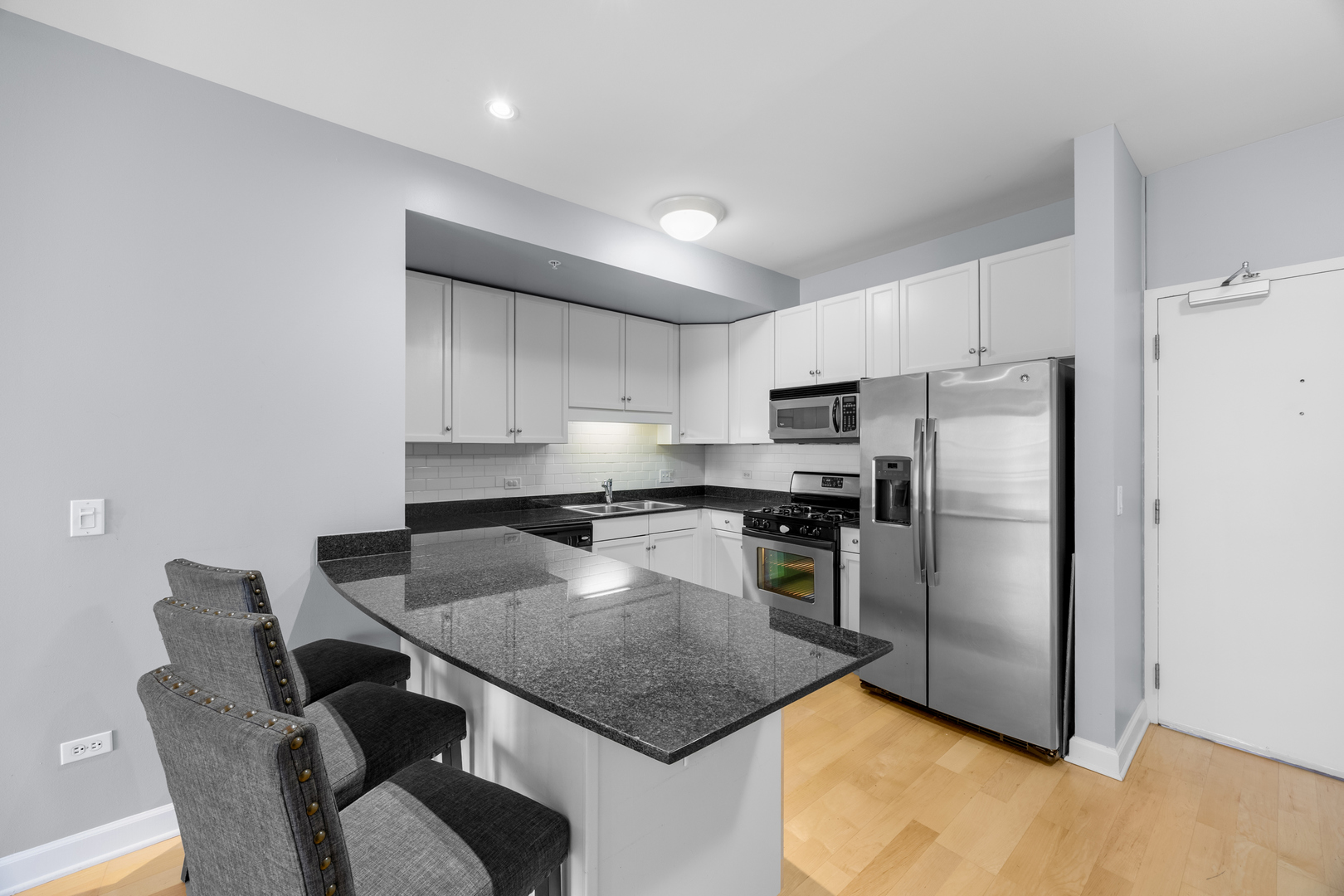 1111 South State Street, Unit A602 Chicago, IL 60605 - Photo 8 of 23 a kitchen with kitchen island a counter top space cabinets stainless steel appliances and a counter space