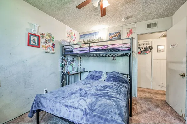 a bed room with a bed and a chandelier