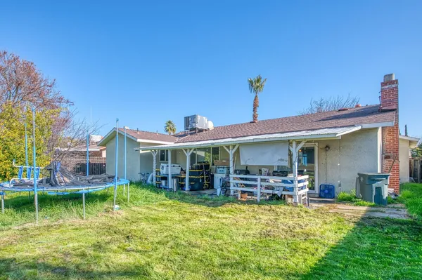 a view of a house with a porch and furniture
