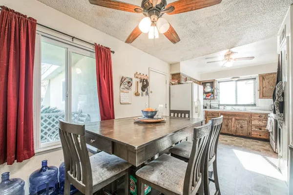 a dining room with furniture window and wooden floor