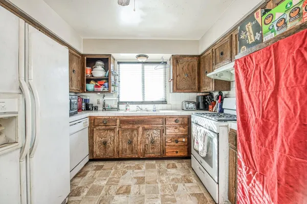 a kitchen with stainless steel appliances granite countertop a refrigerator and a sink