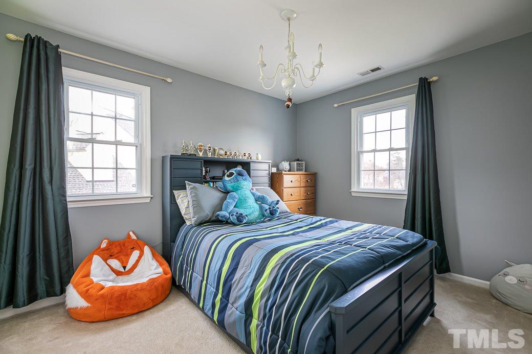 4549 Birmingham Way Raleigh, NC 27604 - Photo 22 of 30 a bedroom with a bed and window