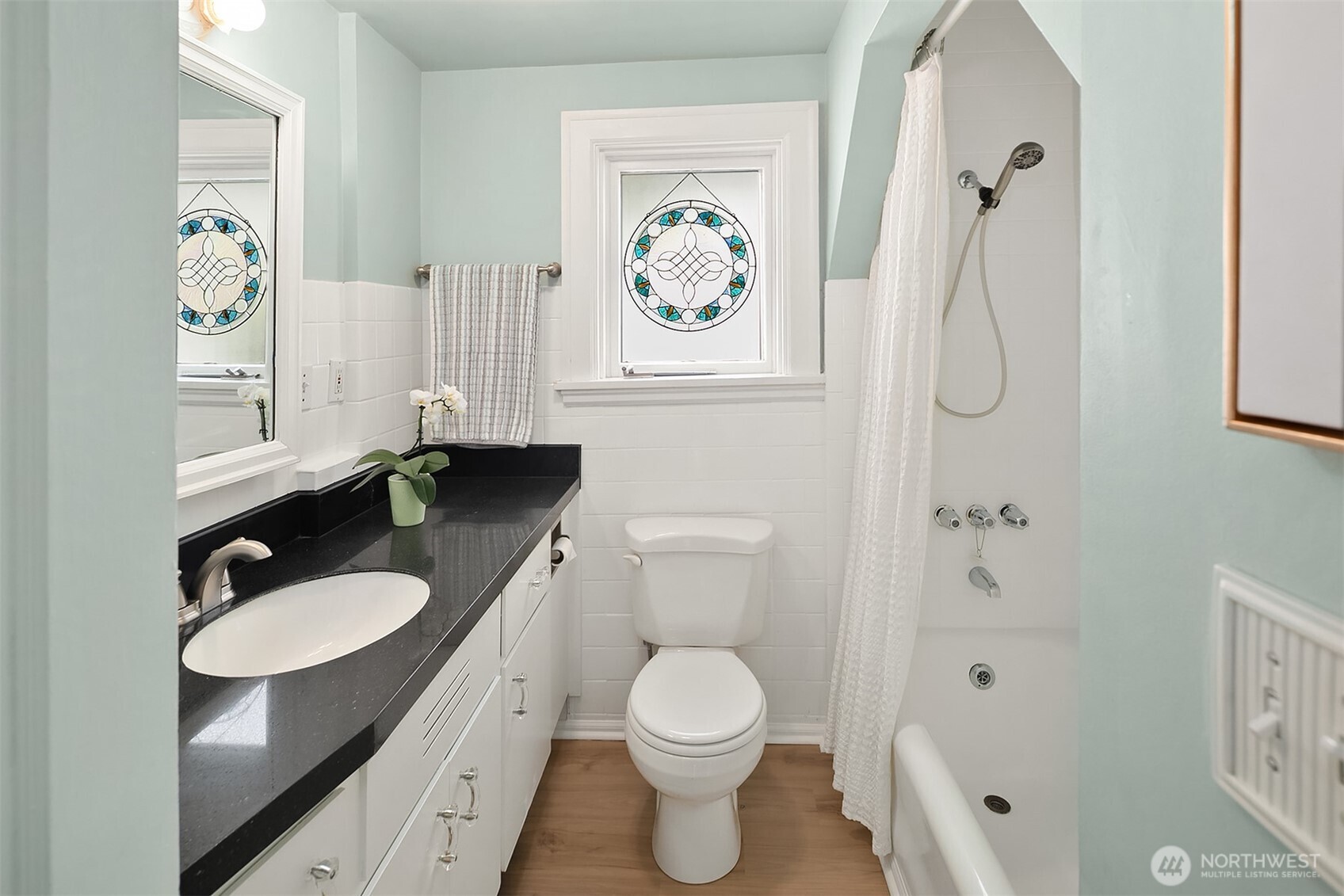 3917 Interlake Avenue North Seattle, WA 98103 - Photo 14 of 36 a bathroom with a granite countertop toilet sink and mirror