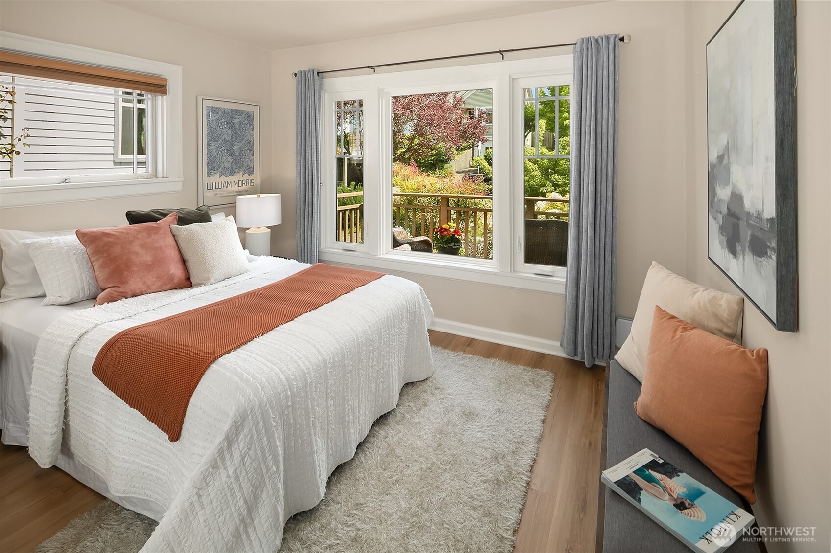 3917 Interlake Avenue North Seattle, WA 98103 - Photo 16 of 36 a bedroom with a bed and large window with chair