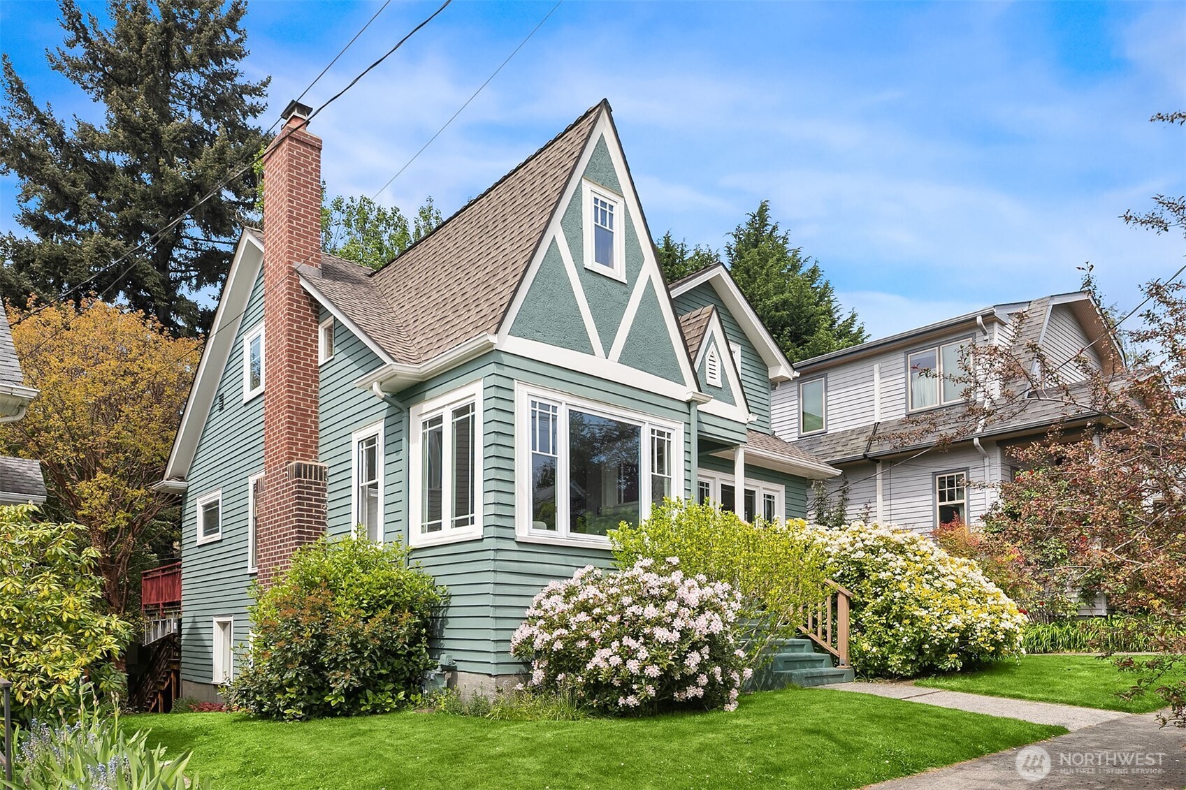 3917 Interlake Avenue North Seattle, WA 98103 - Photo 2 of 36 a view of a brick house with a yard and plants