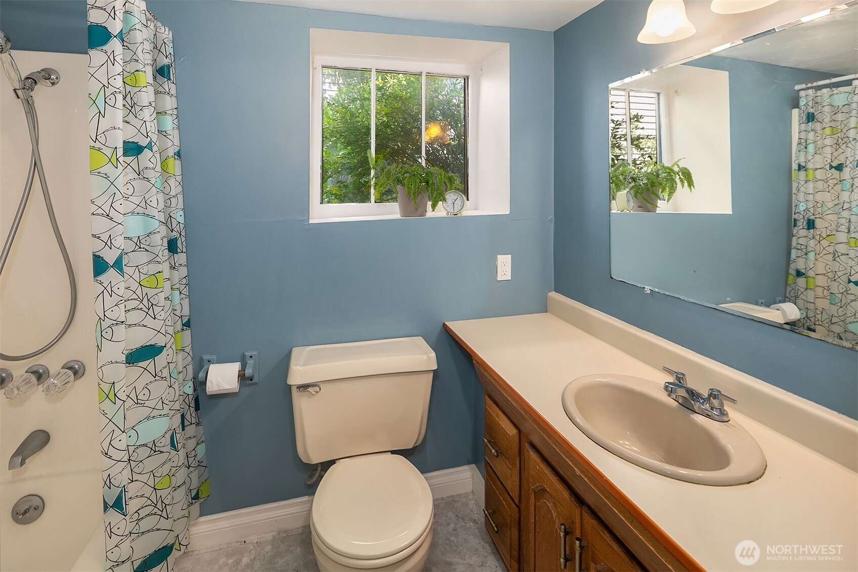 3917 Interlake Avenue North Seattle, WA 98103 - Photo 24 of 36 a bathroom with a sink a toilet and a mirror