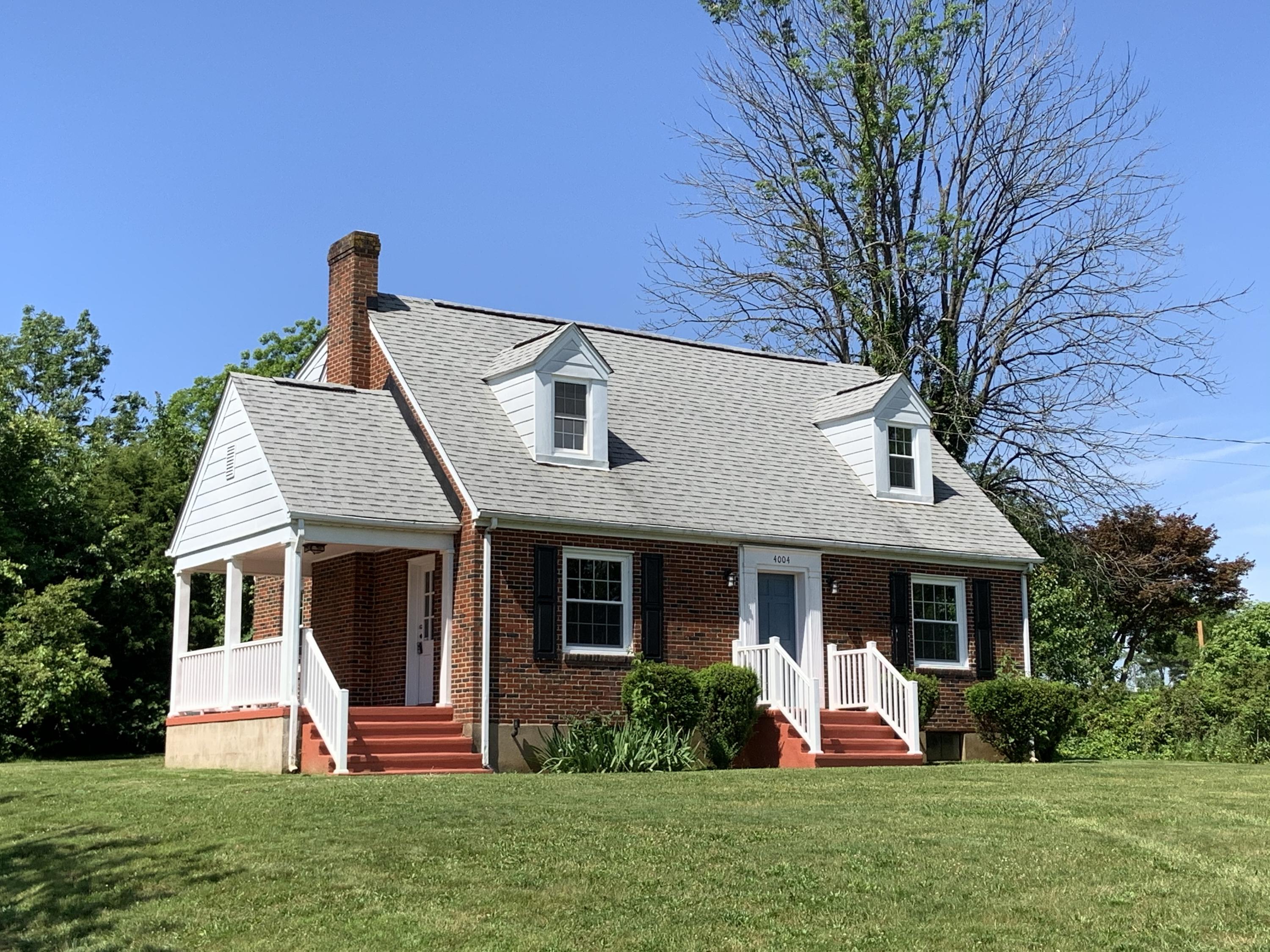 4004 Cove Road Roanoke, VA 24017 - Photo 1 of 30 a front view of a house with a yard and garage