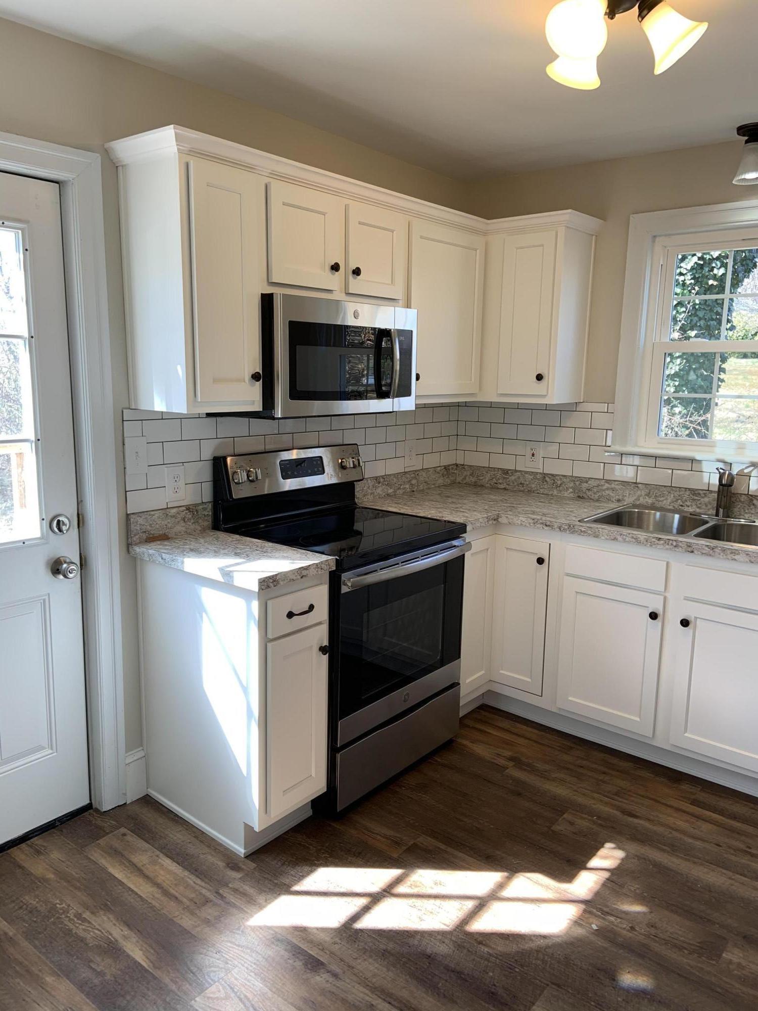 4004 Cove Road Roanoke, VA 24017 - Photo 13 of 30 a kitchen with stainless steel appliances granite countertop a stove a sink and a microwave