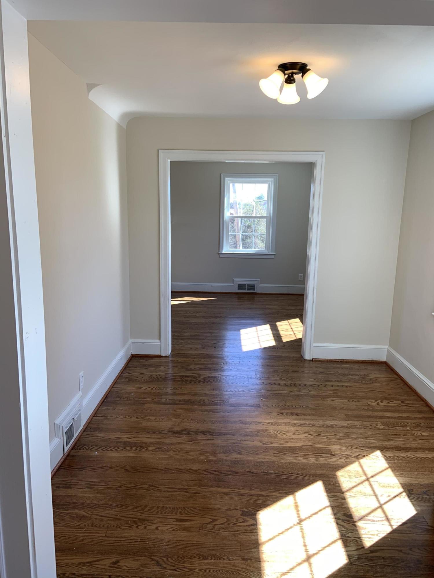 4004 Cove Road Roanoke, VA 24017 - Photo 15 of 30 a view of empty room with wooden floor and window