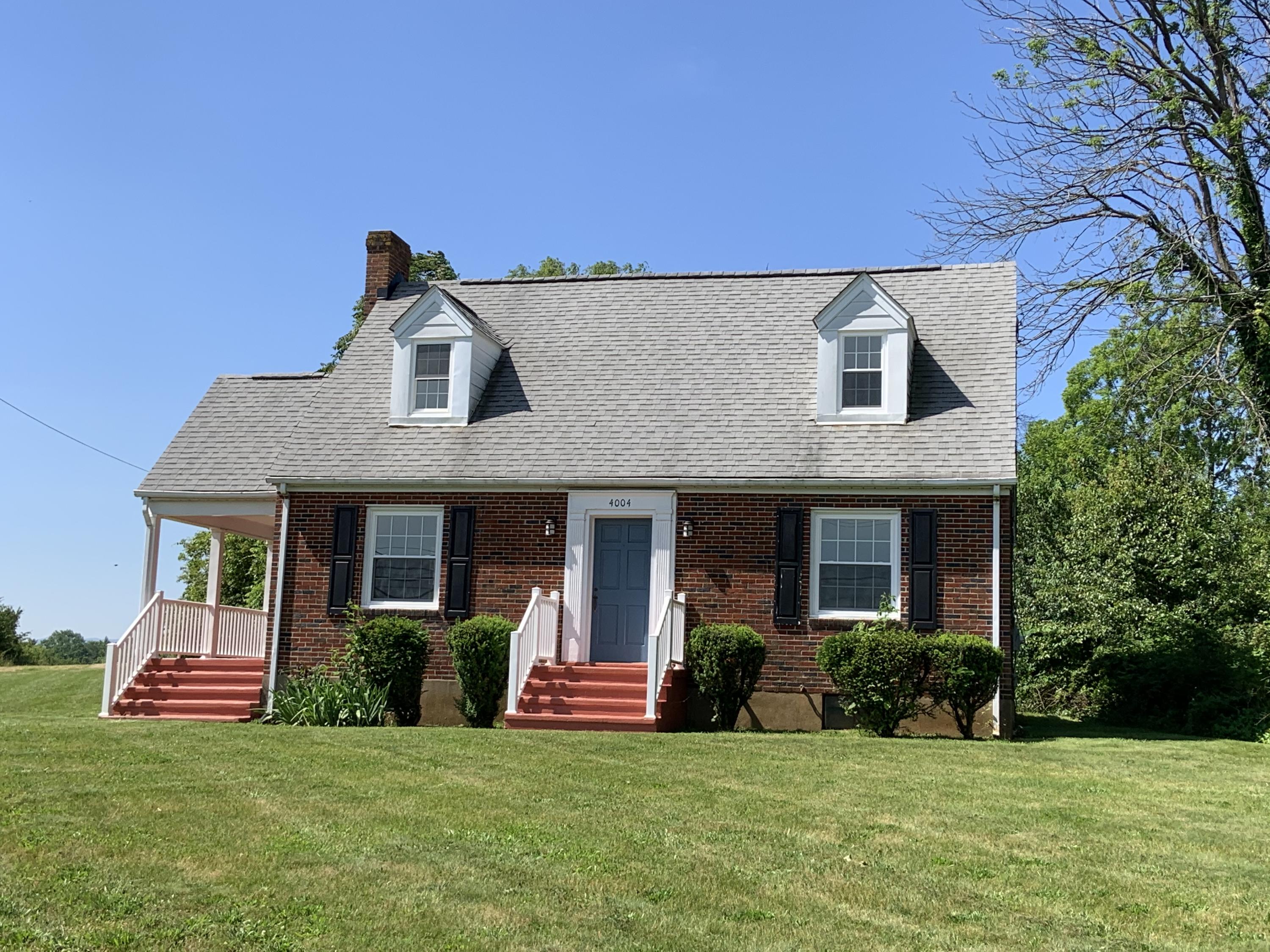 4004 Cove Road Roanoke, VA 24017 - Photo 3 of 30 a front view of a house with a yard and garage