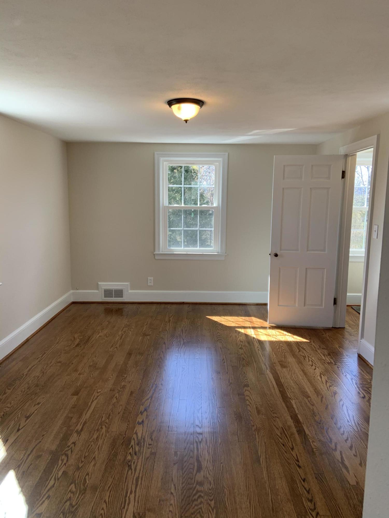 4004 Cove Road Roanoke, VA 24017 - Photo 26 of 30 an empty room with wooden floor and windows