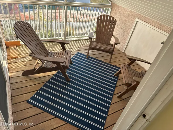 a view of wooden balcony with chairs